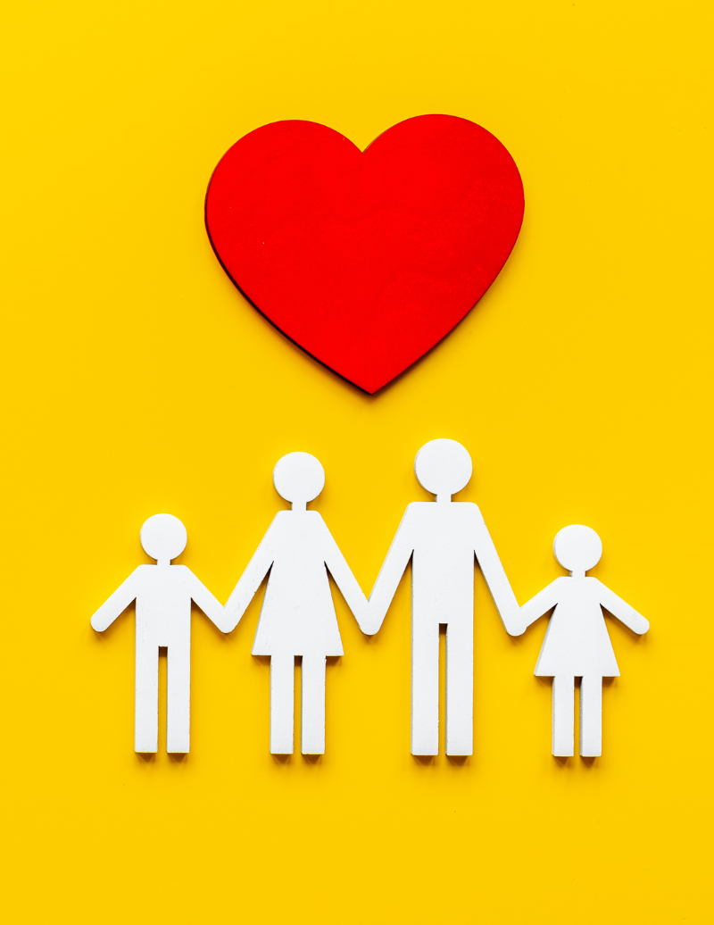 Life Insurance hands with baby shoes
